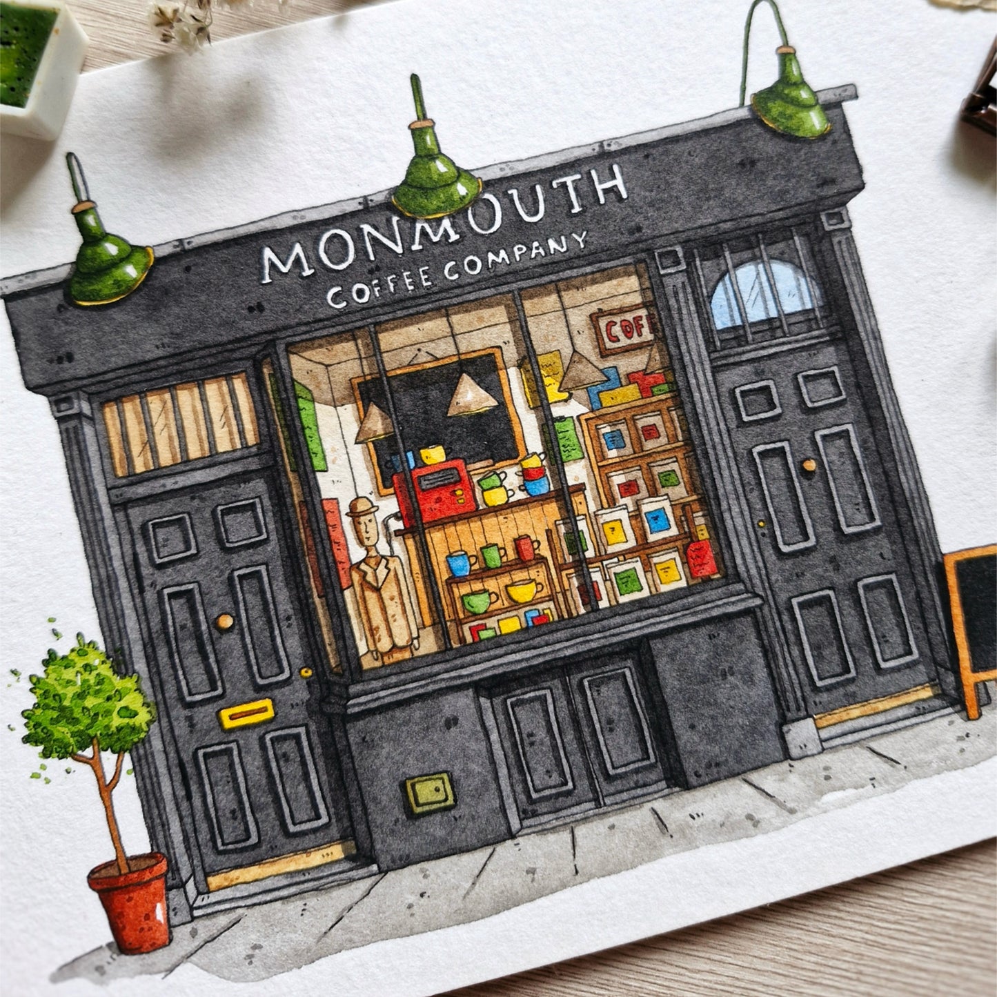 watercolor painting of a coffee shop named 'Monmouth Coffee Company' with a window display.