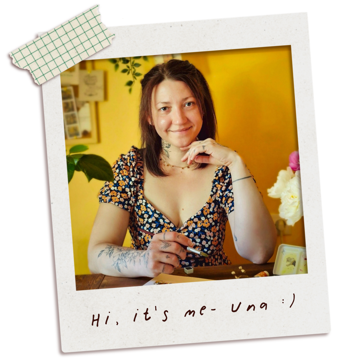Polaroid-style photo of artist named Una , creator of inky paper house sitting at a table with a yellow background