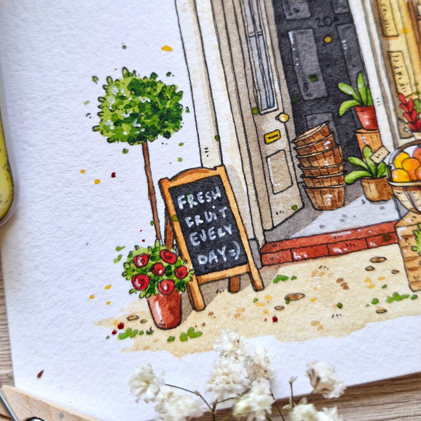 hand painted watercolor painting of a fruit stand with a chalkboard sign and potted plants.