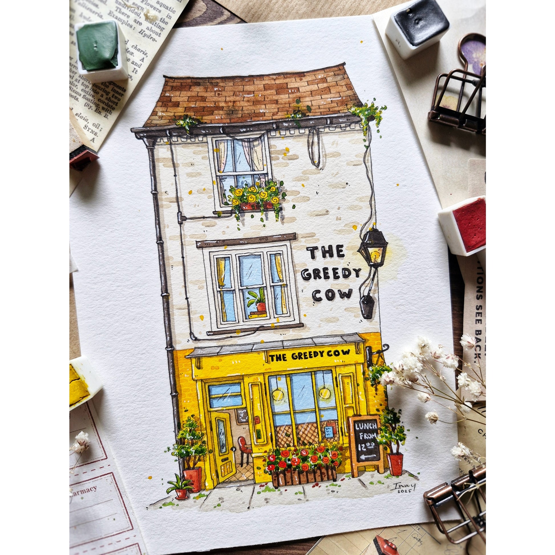 watercolor and ink painting of a building with 'The Greedy Cow' sign 